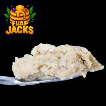 Close-up of Flap Jacks Live Rosin – buttery-golden solventless concentrate with dessert terp profile.